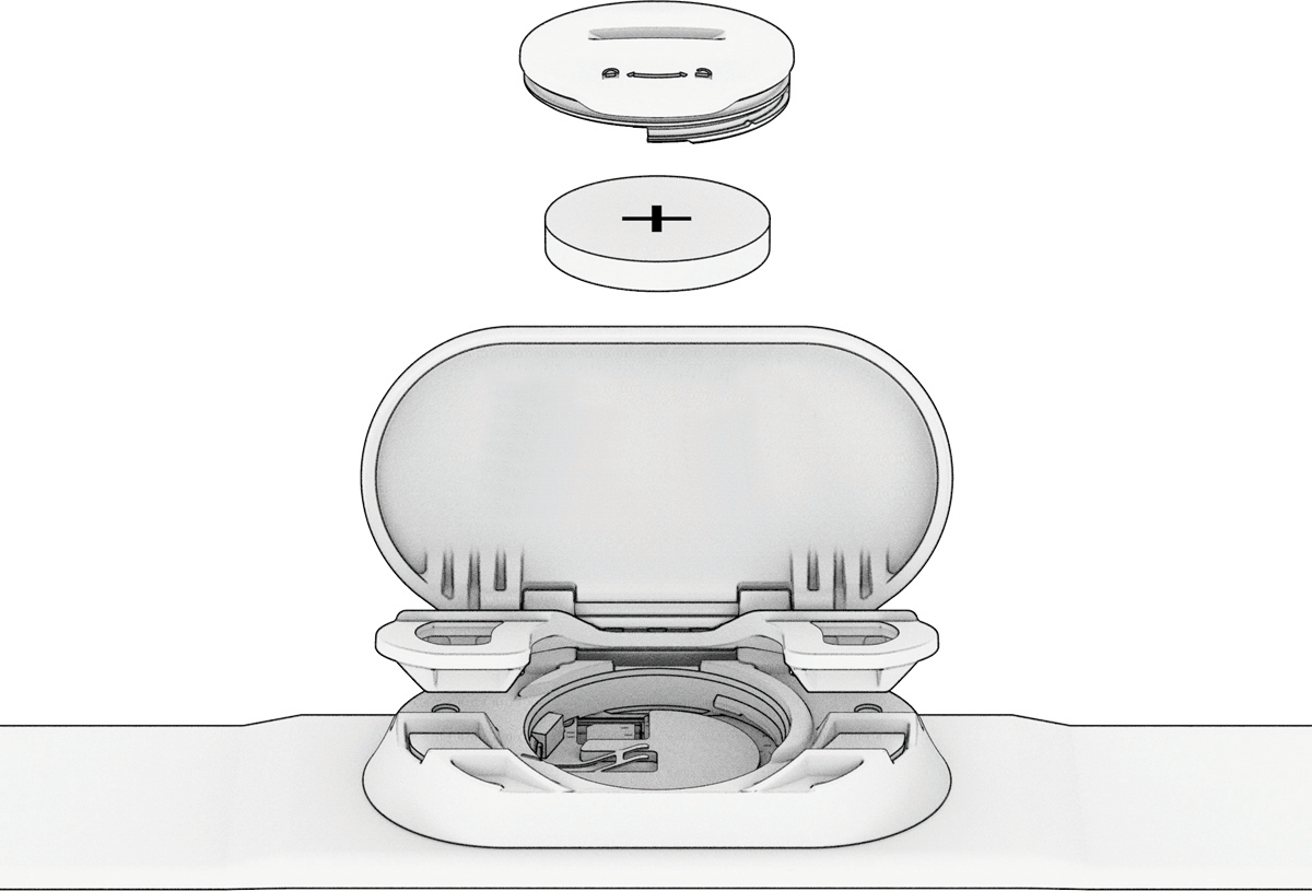 CR2032 battery installed in Garmin HRM sensor with positive side up, close-up