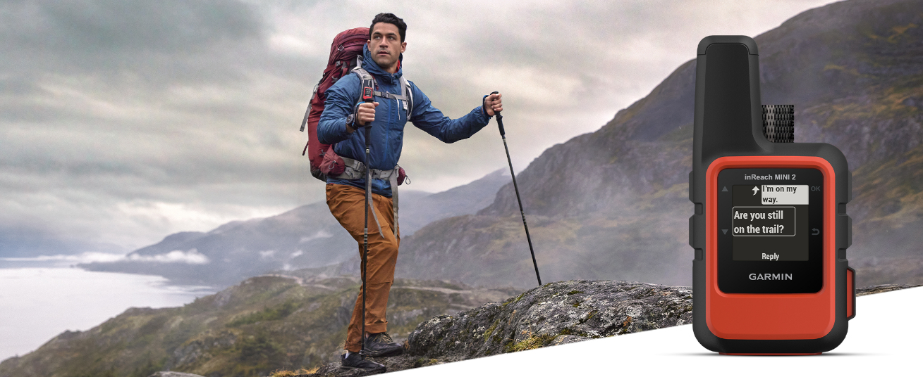 Individual Standing on Hill with inReach Mini 2 Displayed